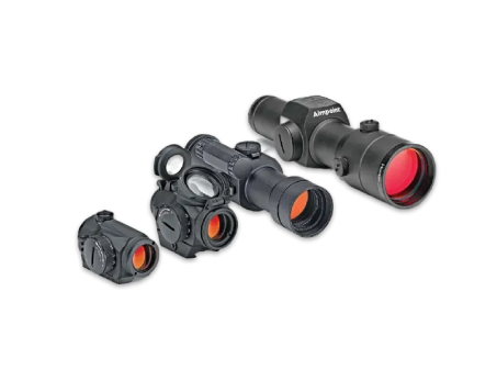 Four different rifle optics, including red dot sights and scopes, displayed side by side.