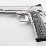 a silver handgun with a black grip